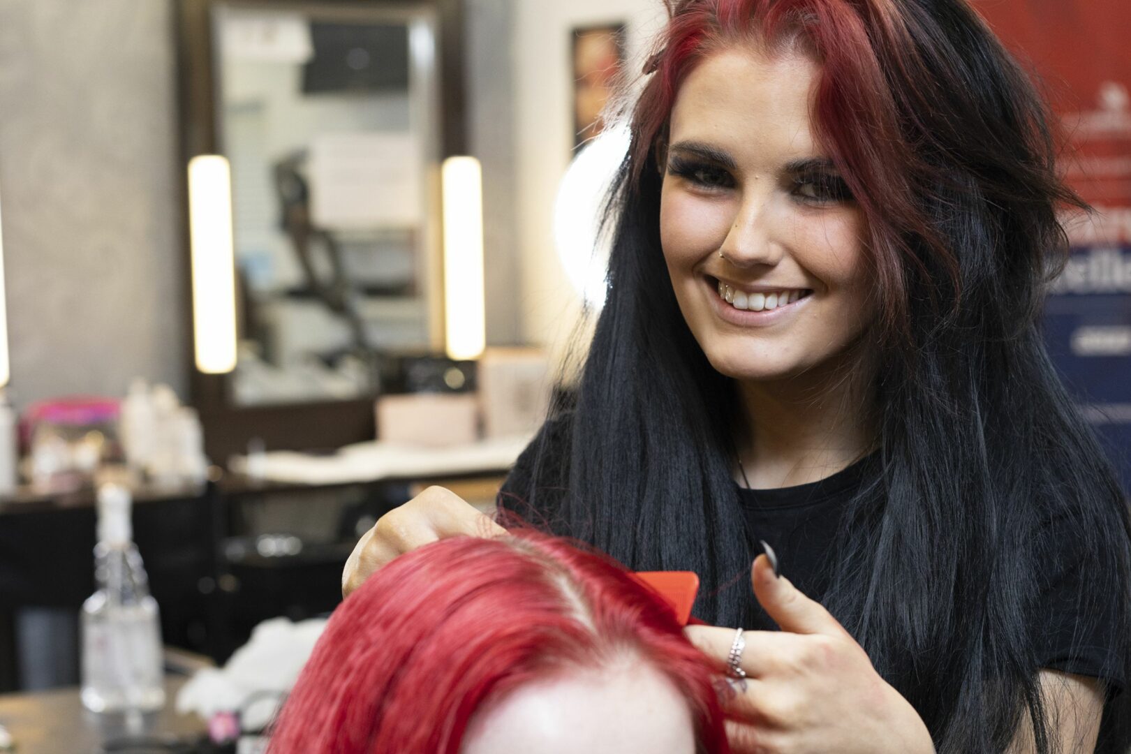 Hairdressing student brushing hair