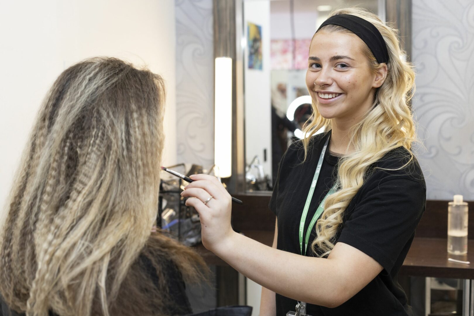 Makeup student applying makeup onto other student