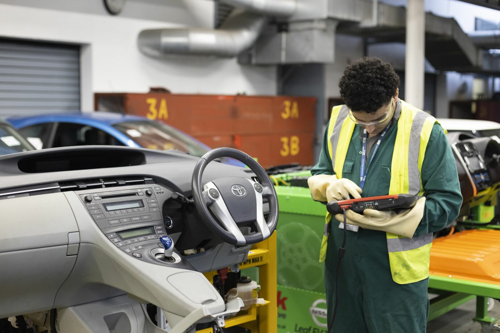 Motor vehicle student working on electric car