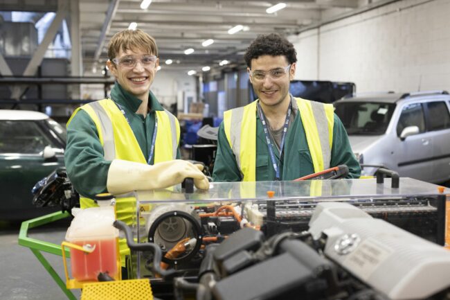 Motor vehicle students working on electrical unit