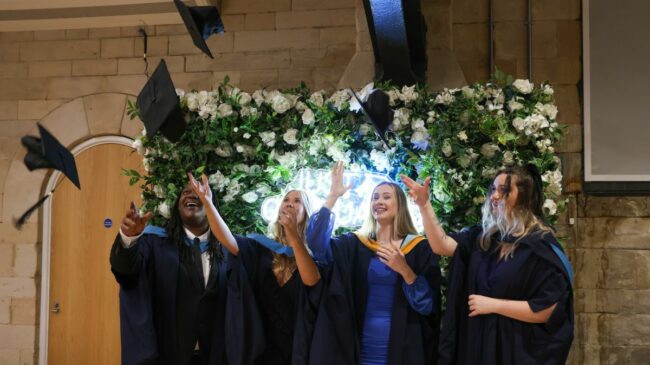 Graduates throwing caps