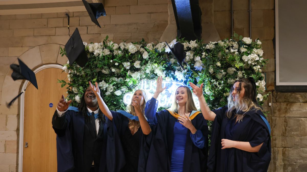 Graduates throwing caps