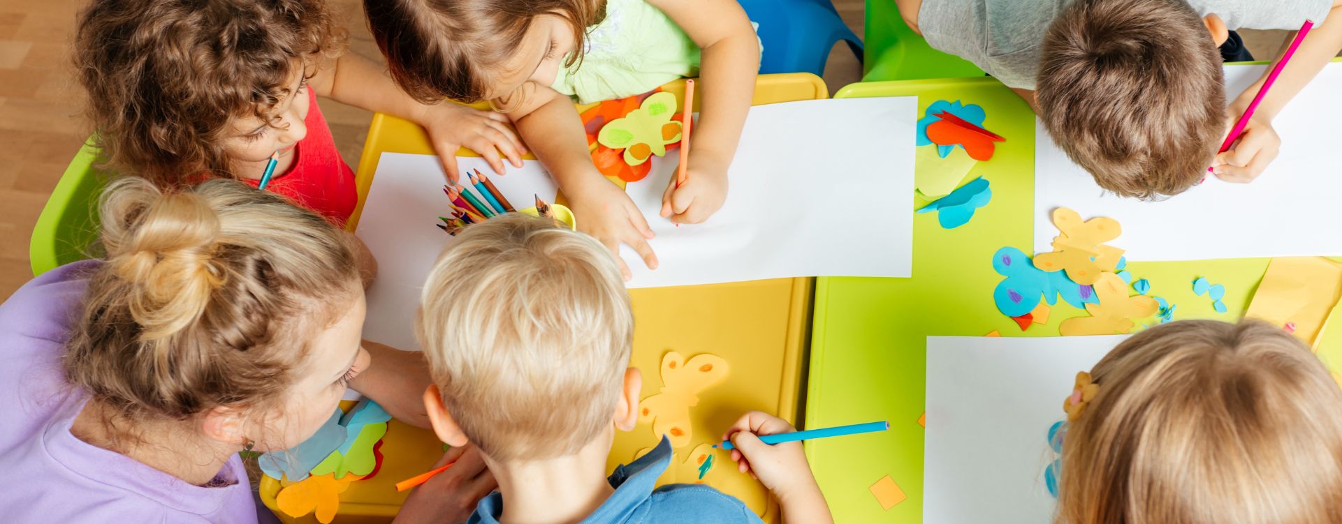 Children and teacher around a table