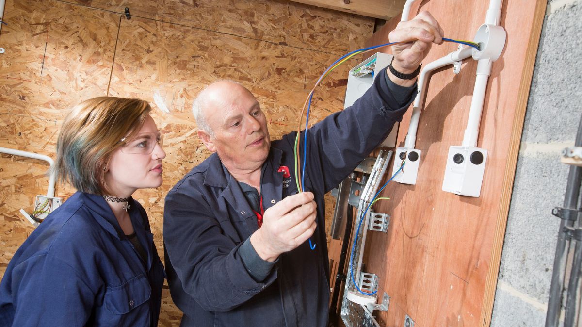 Tutor showing student electrical wiring