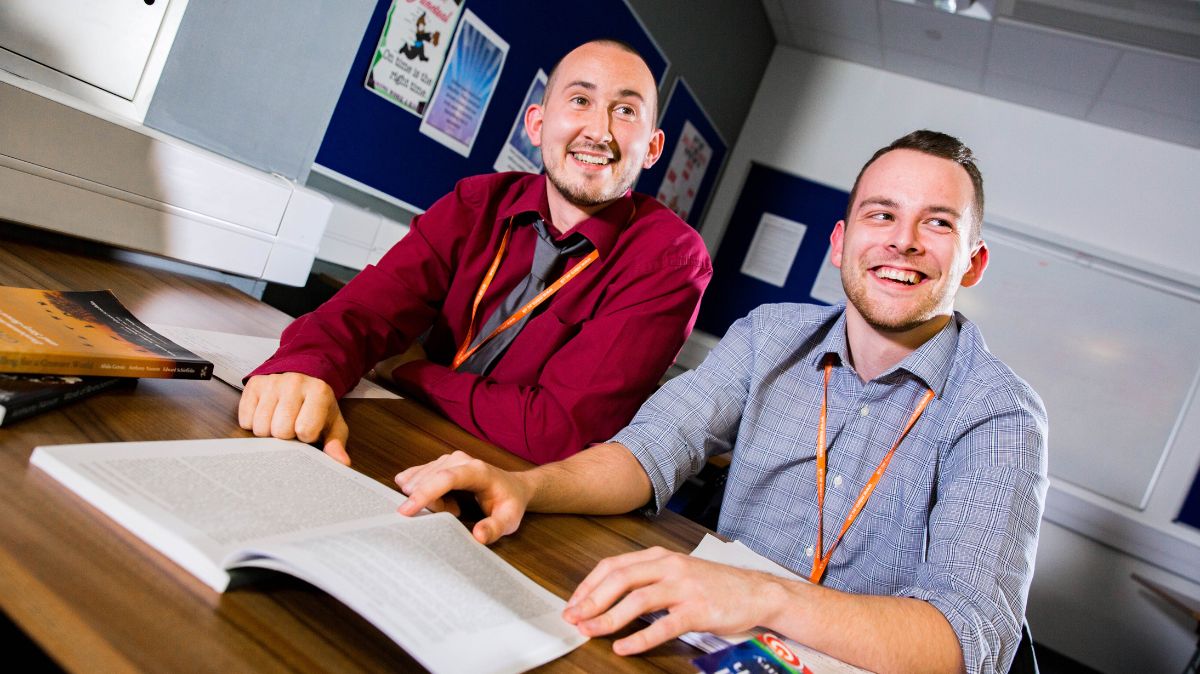 Two students with text book