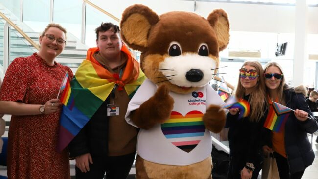 Max the mouse with students and tutor at the Pride Parade