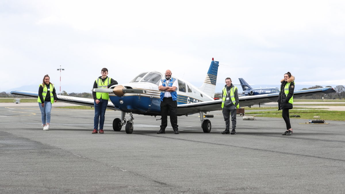 Students next to airplane