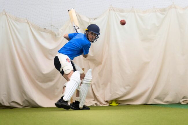 Cricket player about to hit ball