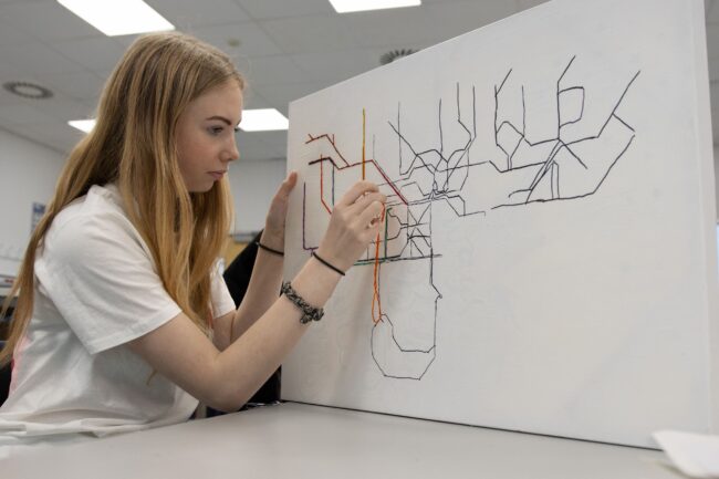 Student creating canvas artwork