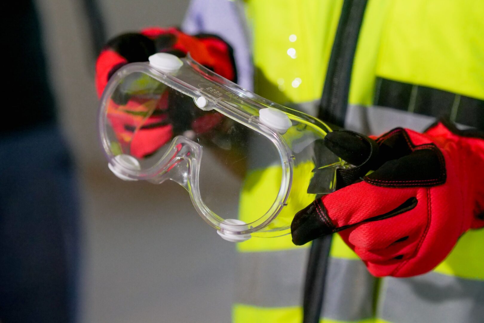 Hands holding goggles