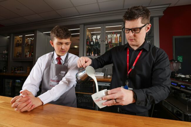 Student And Tutor Pouring Milk