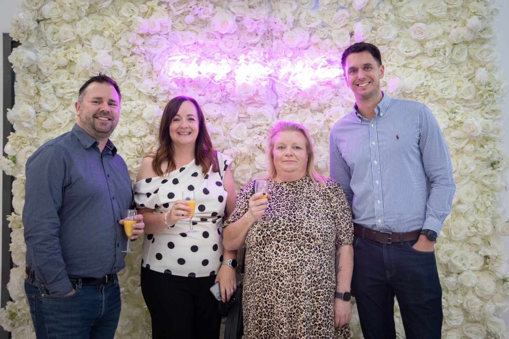 Employers Pose At The Flower Wall