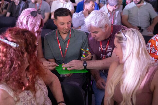 Staff building lego at staff conference