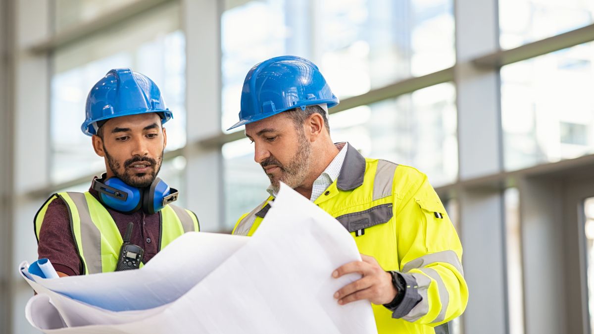 Construction workers with blueprint