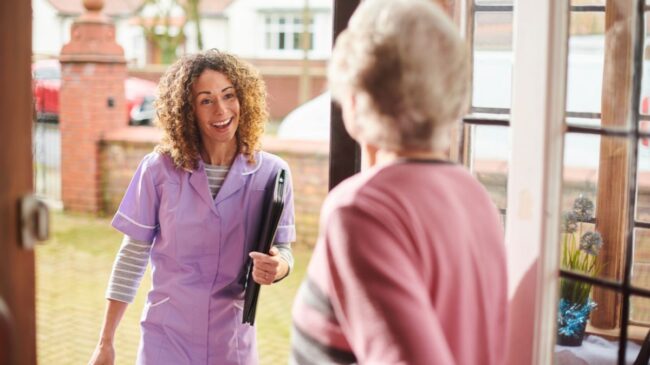 Home carer visiting elderly lady