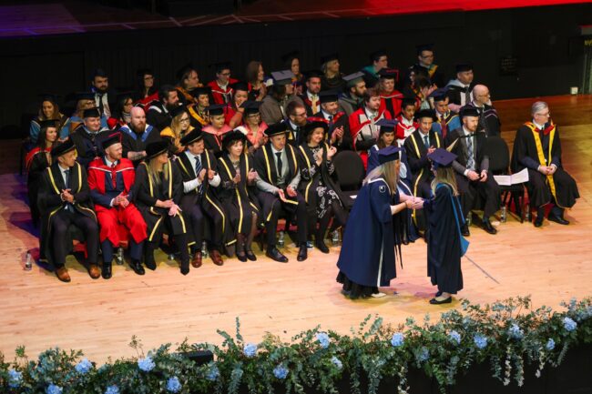 Staff watch graduates