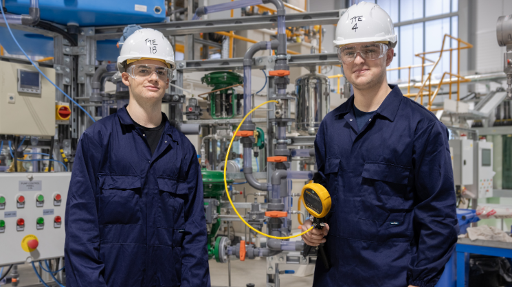 Two students in dark blue PPE stand in TTE