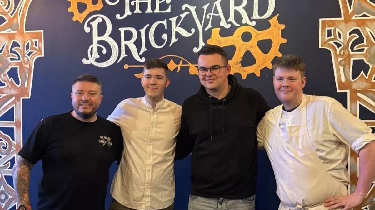 The Brickyard's owners Casey and Cameron Lewis, with World Darts Championship runner-up Gian Van Veen