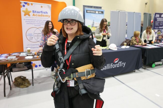 Staff member tries on equipment