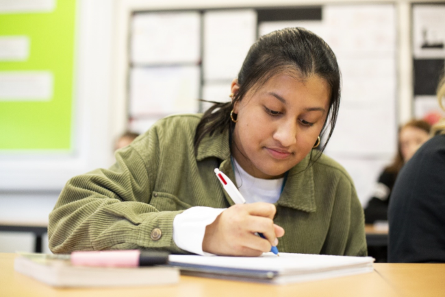 Student studying and completing exam tasks
