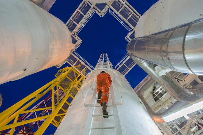Man climbing oil rig