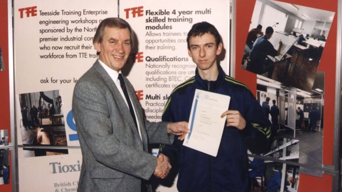 TTE’s MD Tom Lough presents a certificate to apprentice Paul Bradshaw