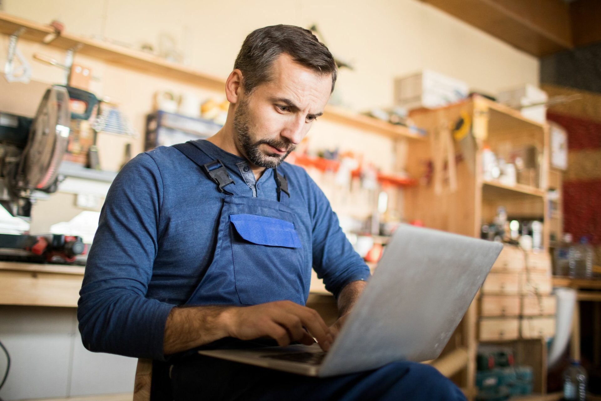 Man in workshop on laptop