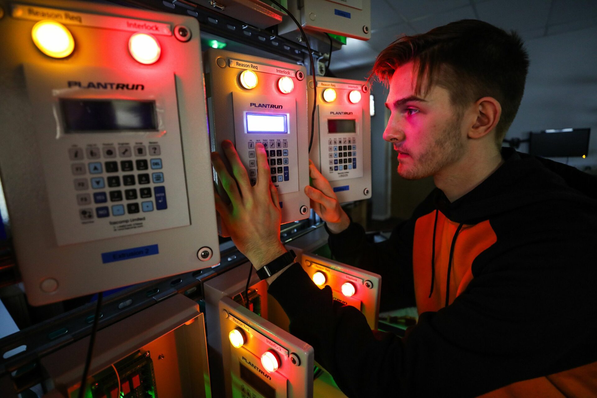 Apprentice looking at electrical unit