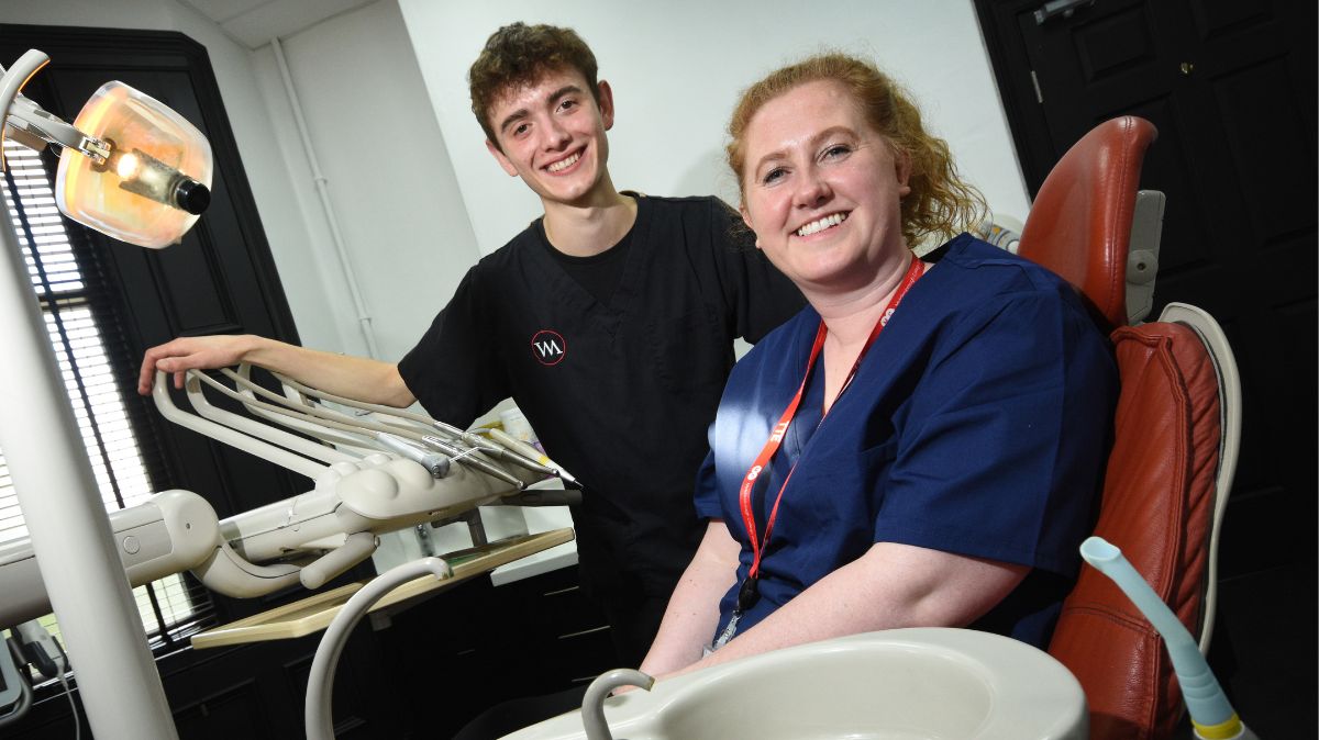 Dental apprentice with staff member